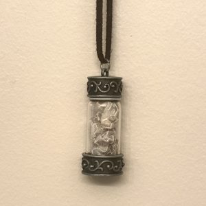 close up of decorative jar charm with snake shed inside